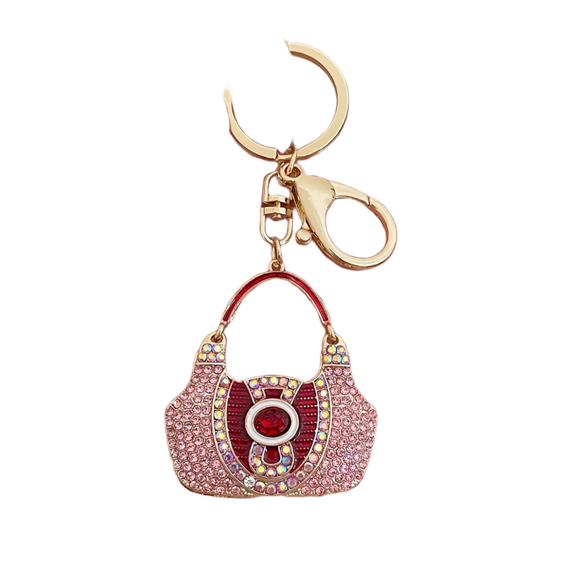 Luxe Purse Keychain with a sparkling rhinestone design, crafted from durable zinc alloy. Compact and lightweight at 1.44 oz, measuring 4.72 inches by 1.97 inches, perfect for adding a touch of elegance to your keys or bag.