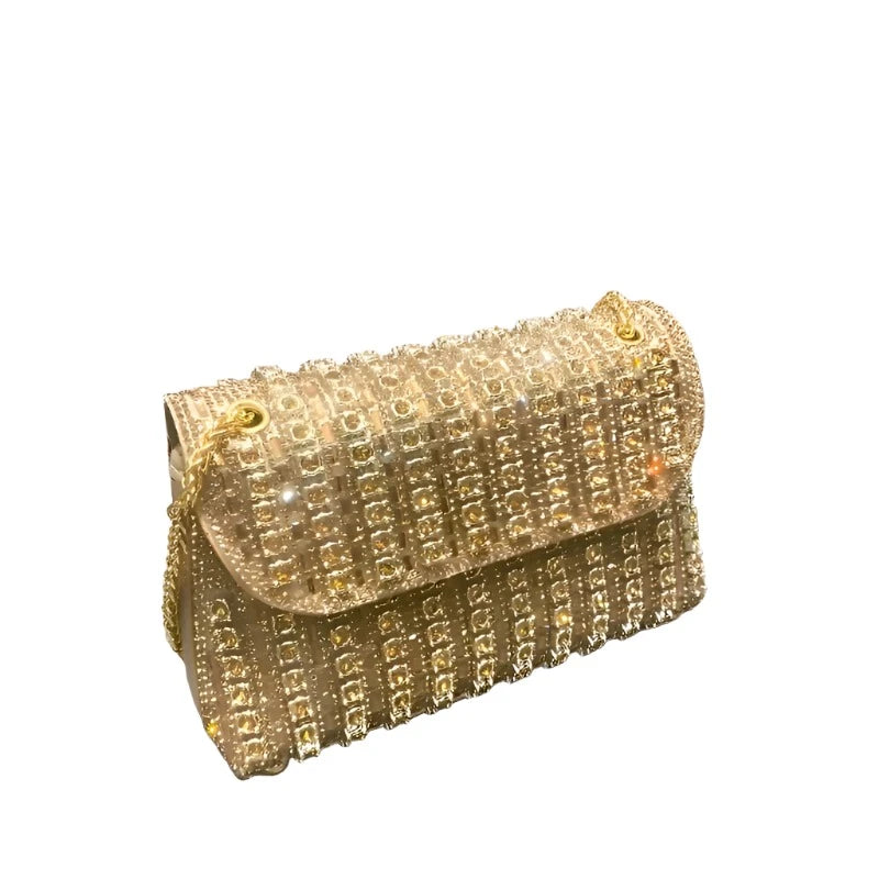 A luxurious black clutch bag with intricate gold detailing, elegantly designed for evening wear. The Mademoiselle Enchanted Clutch exudes sophistication and charm, perfect for special occasions and formal events.