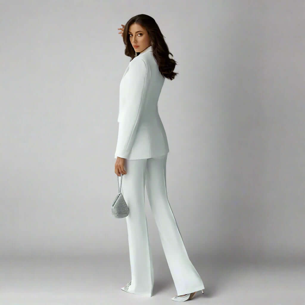 Zoharas Fashion Collection Two Piece White Pant Suit with Slim Flare Legs designed for versatility, whether you’re attending a formal event or a business meeting.