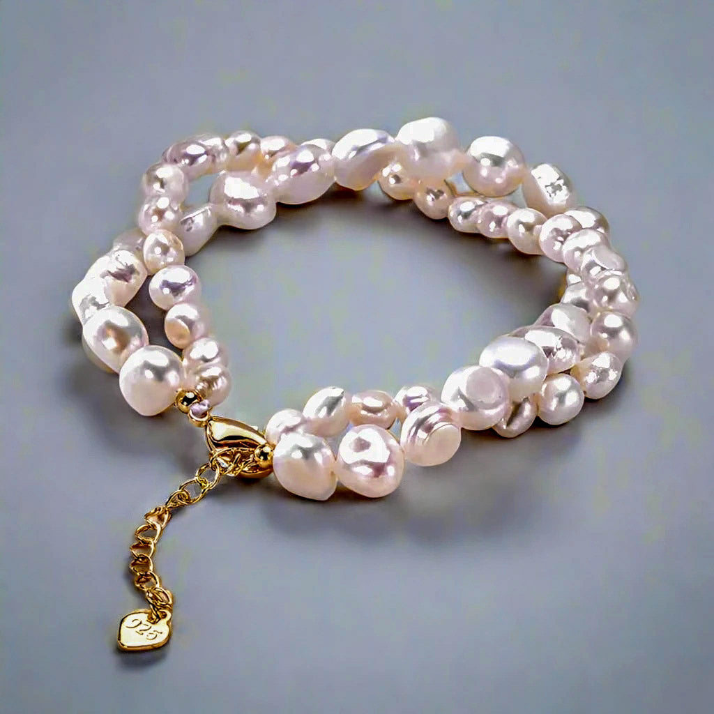 Zoharas Vogue White Rice Pearl Bracelet elegantly displayed, featuring lustrous freshwater pearls uniquely shaped for natural beauty, paired with 925 sterling silver accents for timeless sophistication. A versatile accessory perfect for special occasions or adding classic charm to everyday outfits.