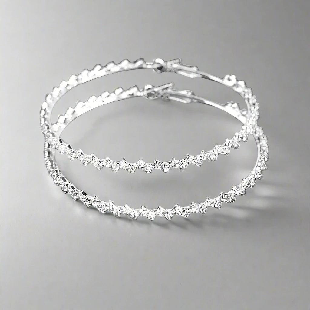 Elegant silver hoop earrings with crystal accents, 4cm in diameter, available at Zoharas Fashion Collection.