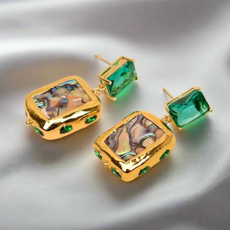 Zoharas Vogue Aurora Abalone Drop Earrings crafted with abalone shell and green crystals, featuring gold-plated accents and a unique square design. Lightweight at 0.74 oz, perfect for adding elegance and sophistication to any occasion.